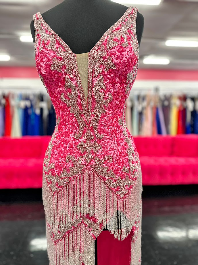 The Jovani 38847 Prom Dress is a stunning gown that exudes elegance and glamour. Made with exquisite sequin beading and delicate fringe details, this dress will make you feel like a star on any special occasion. Featuring a sexy slit and a flattering V-neckline, it's the perfect choice for proms, pageants, and formal events. Look and feel your best with this one-of-a-kind dress.
