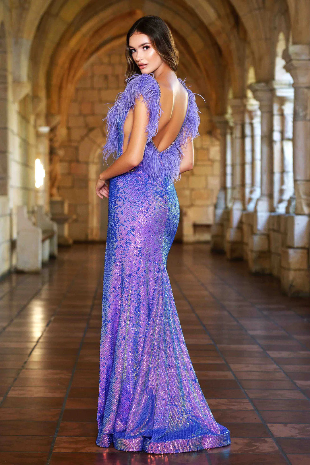 The Ava Presley 38896 dress features a stunning fitted sequin silhouette and feather detailing along a flattering v-neckline, and a daring open back. Perfect for proms and pageants, this gown will make you feel confident and glamorous.  Sizes: 00-16  Colors: Powder Blue, Iridescent Purple, Red, Iridescent Black, Black, Off White