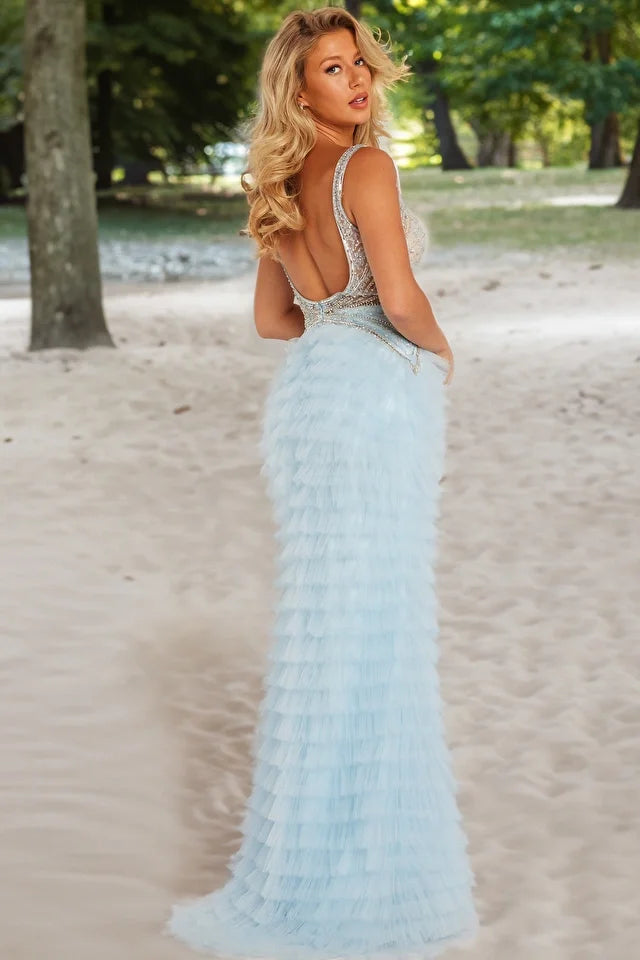 The Jovani 38912 is a breathtaking prom dress that belongs to the formal collection, perfect for making a lasting impression at your prom. This dress is crafted from tulle, a delicate and lightweight fabric that imparts a sense of whimsy and romance. The style of the dress is maxi, offering a floor-length hem that provides an elegant and graceful appearance. The layered skirt features a high slit, which adds a touch of drama and allure while allowing for easy movement. 