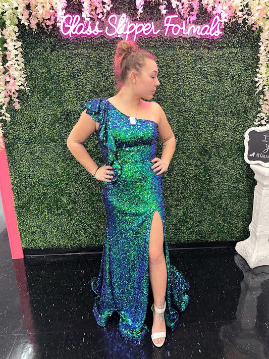 Ava Presley's 39280 Prom Dress is sure to make a stunning statement. Crafted from iridescent sequins, this one-shoulder gown features a ruffle-trimmed neckline, and a dramatic side slit. Perfect for prom, pageants, and other special occasions.  Sizes: 10  Colors: Iridescent Teal