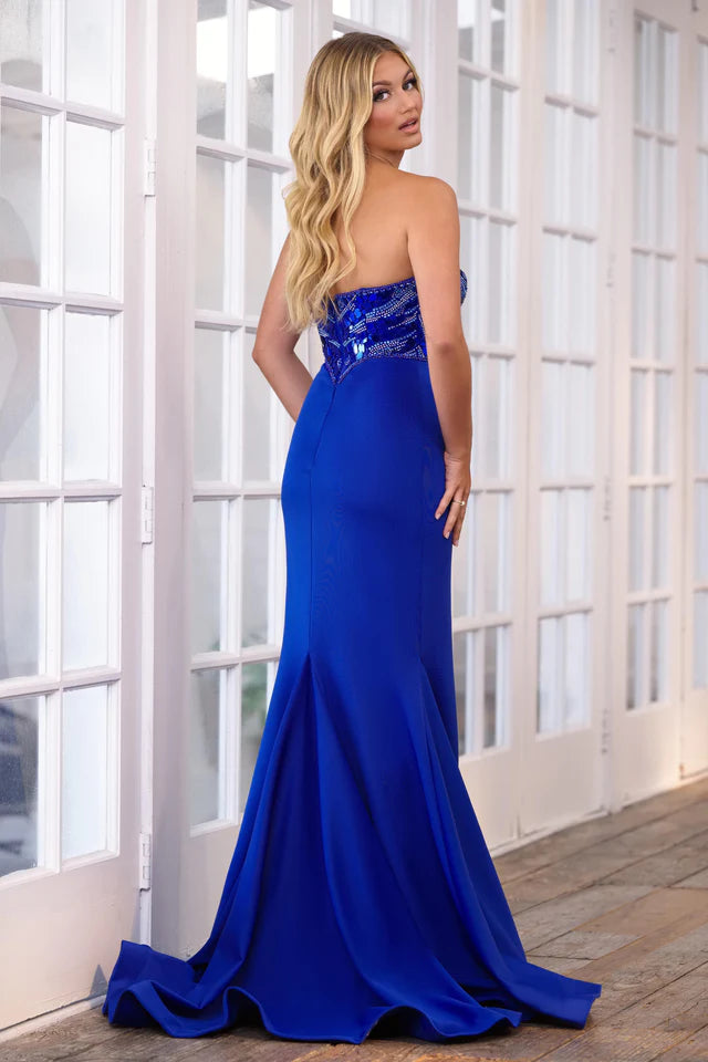 The Ava Presley 39281 Prom Dress is a stunning choice for any formal event. The sleeveless design and high slit provide a sleek and elegant look, while the beaded detailing adds a touch of sparkle. The glass break pattern adds a unique and modern twist to this classic silhouette. Perfect for pageants and prom, you'll feel like a queen in this gown.