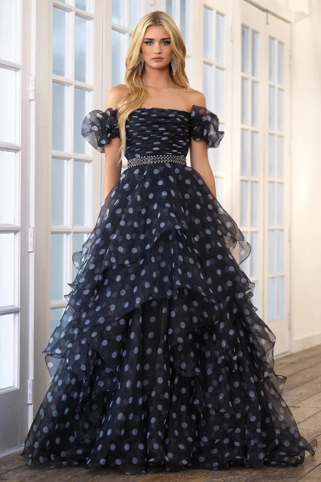 This Ava Presley 39318 prom dress is the perfect choice for any formal occasion. Its off the shoulder design and open back add a touch of elegance, while the layered organza ruffles create a unique and flattering silhouette. Turn heads and feel confident in this stunning pageant gown.