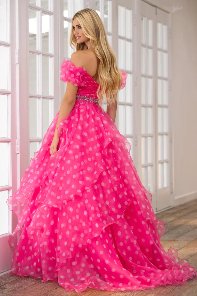 This Ava Presley 39318 prom dress is the perfect choice for any formal occasion. Its off the shoulder design and open back add a touch of elegance, while the layered organza ruffles create a unique and flattering silhouette. Turn heads and feel confident in this stunning pageant gown.