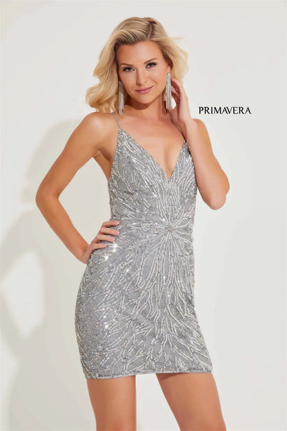 Primavera Couture 4011 Cocktail dress. Crafted with sequin and beaded designs, this beautiful dress features a deep V-neck and low tie back. Perfect for homecoming, cocktail, and other formal events.&nbsp;Introducing the stunning Primavera Couture 4011 Homecoming Dress, showcasing intricate sequin detailing and a dramatic backless design with a corset fit. Perfect for any cocktail or formal event.