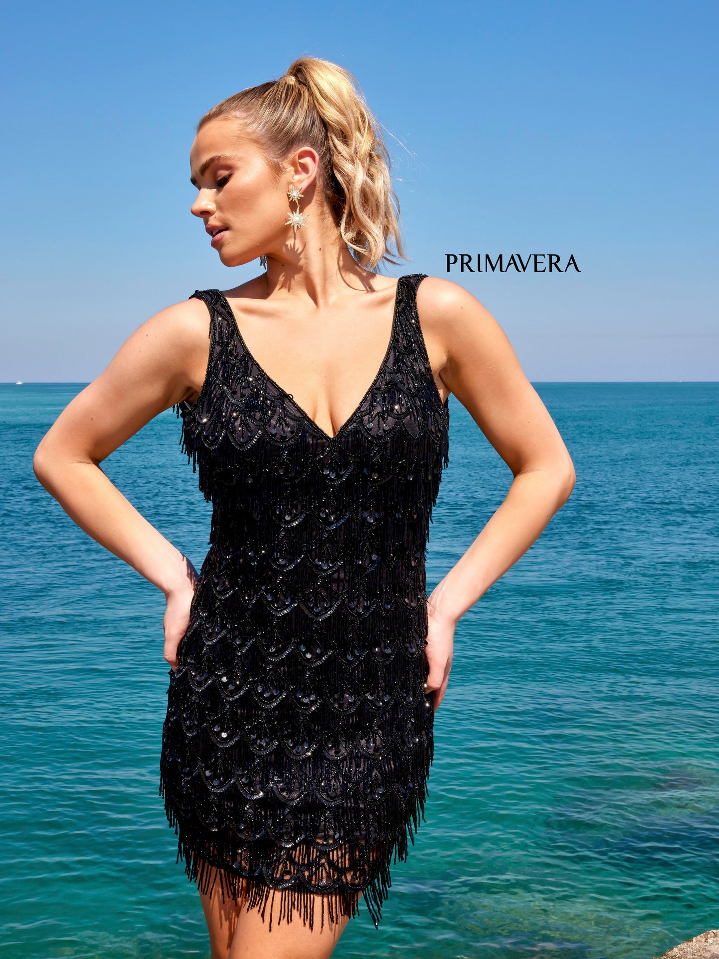 Primavera Couture 4042 Beaded Embellished Fringe With Stones V-Neck Cocktail Homecoming Dress. This Primavera Couture dress is sure to make a statement. A V-neck style adorned with beaded fringe, stones, and embellishments creates a unique and polished look with modern appeal. Perfect for a special occasion.