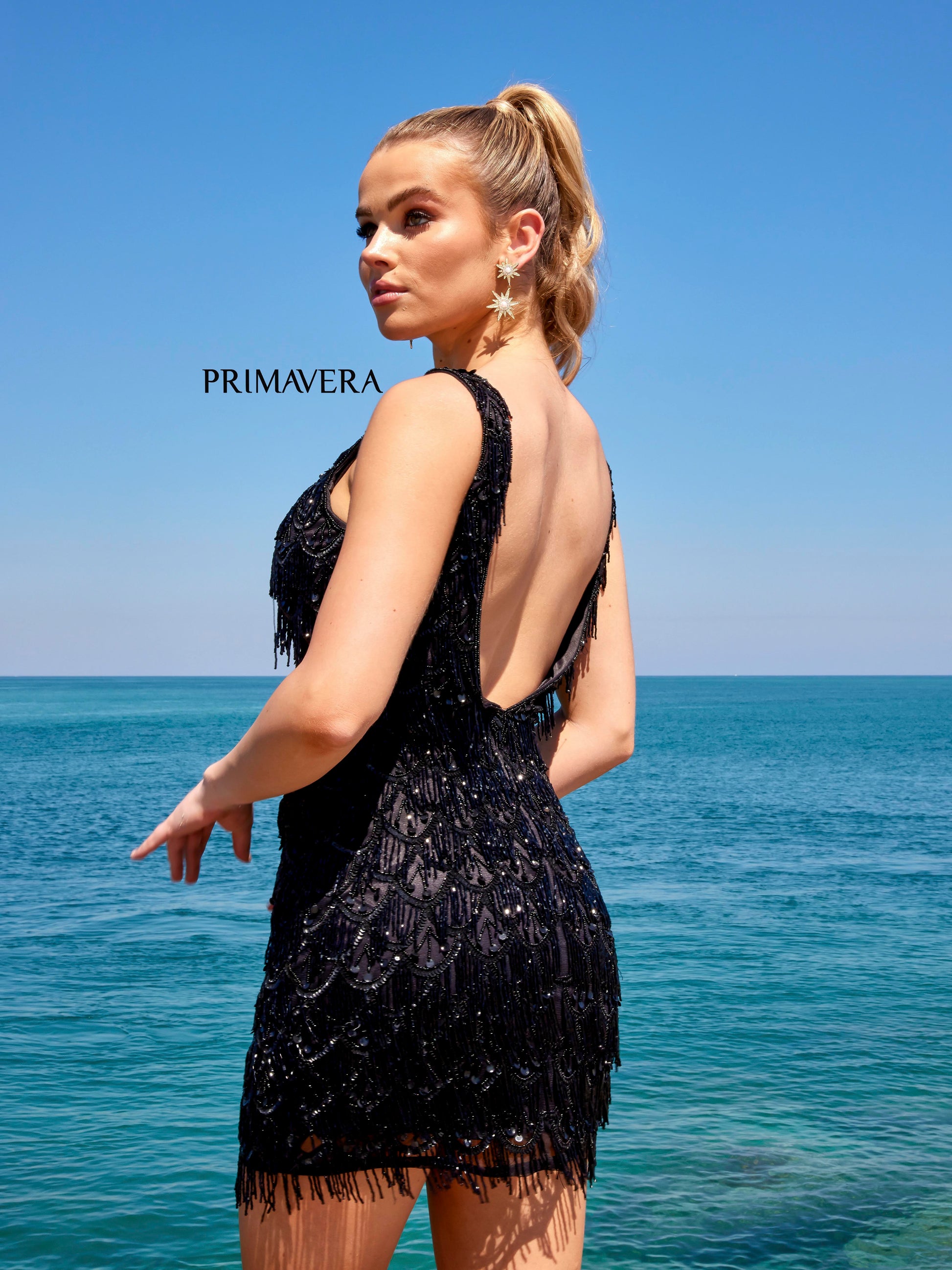 Primavera Couture 4042 Beaded Embellished Fringe With Stones V-Neck Cocktail Homecoming Dress. This Primavera Couture dress is sure to make a statement. A V-neck style adorned with beaded fringe, stones, and embellishments creates a unique and polished look with modern appeal. Perfect for a special occasion.
