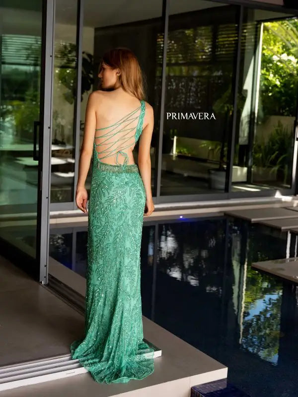 Looking for a show-stopping prom dress? Look no further than the Primavera Couture 4101. This stunning gown features intricate sequin and bead detailing, a flattering corset bodice, and a one shoulder design. The fitted cut out silhouette is perfect for any formal event or pageant. Level up your style and confidence in this eye-catching dress.
