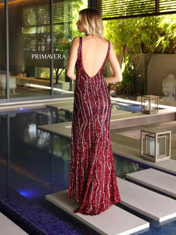 Elevate your formal event with the Primavera Couture 4103 Long Prom Dress. With its fitted silhouette and high slit, this sequin gown is designed to flatter your figure and catch the eye. The V-neck and open V-back add a touch of elegance, making it the perfect choice for a pageant or prom.