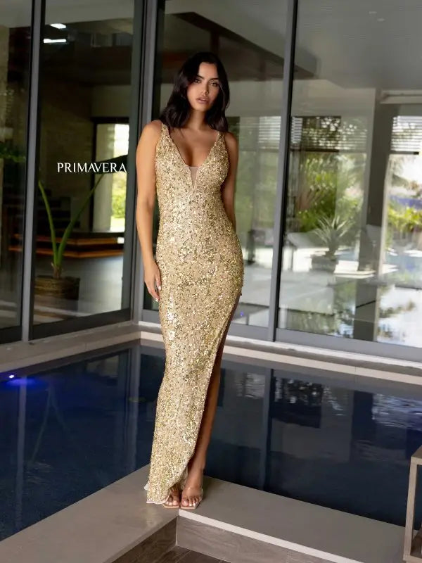 Make a statement at your next formal event in this stunning Primavera Couture 4104 long prom dress. The fitted silhouette is adorned with intricate sequins and beads, while a daring cut out v-neck and open back add a touch of allure. Perfect for pageants or any special occasion, this gown is sure to turn heads.