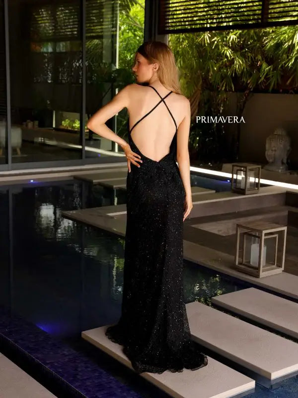 Indulge in luxury with the Primavera Couture 4109 Long Prom Dress. Embellished with sequins and a criss-cross open back, this gown exudes elegance. The fitted design flatters the figure while the high slit adds a touch of glamour. Perfect for formal events and pageants.