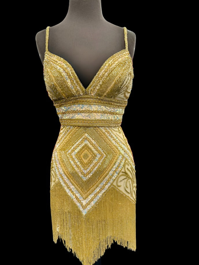 Be the center of attention in the Jovani 41101 Short Beaded Fringe Cocktail Dress. The stunning sequin skirt, v-neckline, and corset top make for a glamorous and figure-flattering look. Perfect for homecoming or any formal event, this dress offers 100% style with no compromise on comfort.  Sizes: 2  Colors: Gold