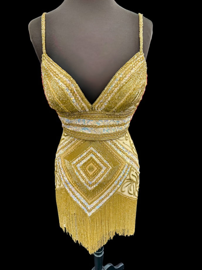 Be the center of attention in the Jovani 41101 Short Beaded Fringe Cocktail Dress. The stunning sequin skirt, v-neckline, and corset top make for a glamorous and figure-flattering look. Perfect for homecoming or any formal event, this dress offers 100% style with no compromise on comfort.  Sizes: 2  Colors: Gold