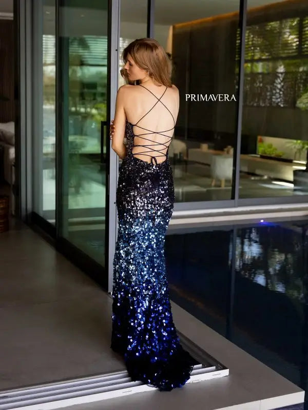Expertly crafted by Primavera Couture, this stunning prom dress features a flattering corset top and a high slit design for a touch of sultry elegance. The ombre effect adds a unique twist, while the scoop neck and fitted silhouette provide a sophisticated and formal look. Perfect for pageants or any special occasion.