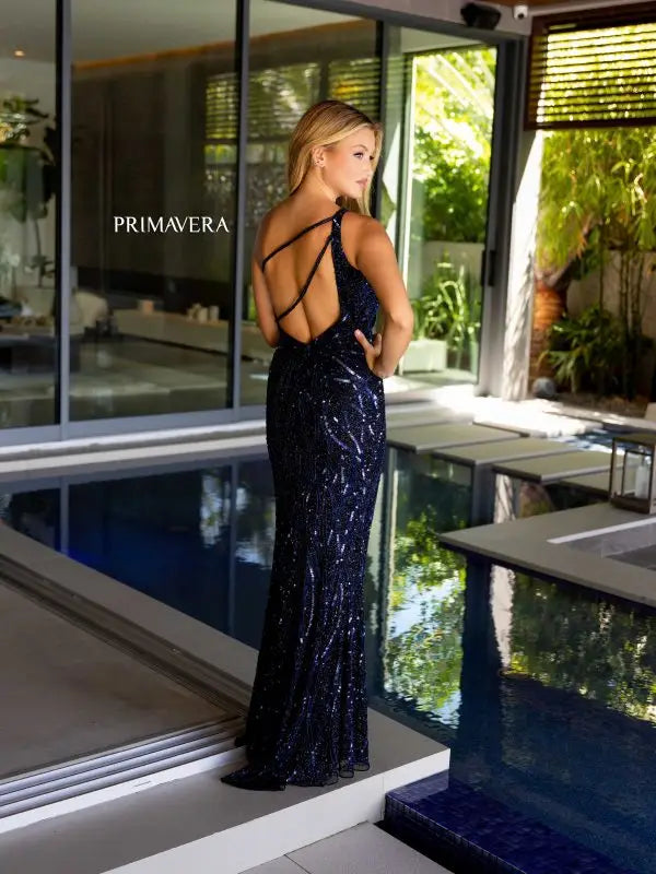 As a stunning piece from Primavera Couture, the 4118 Long Prom Dress features a one shoulder design with a cut out detail that adds a touch of sophistication. The sleek and fitted silhouette is adorned with sequins, making it a perfect choice for any formal event or pageant. The high slit adds a subtle hint of sexiness while maintaining its elegant appeal. Step out in style and confidence with this gorgeous dress.