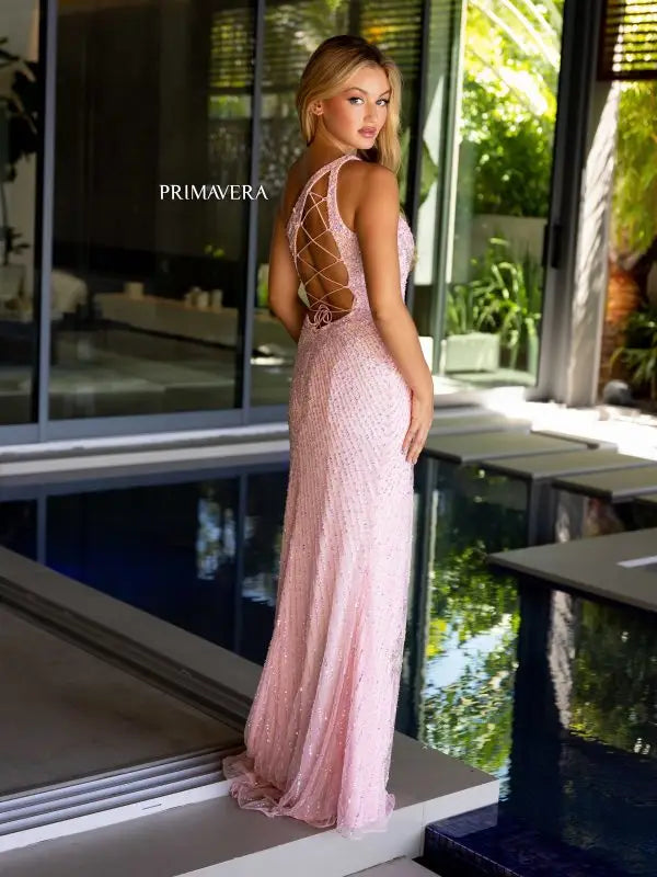 Elevate your prom or pageant look with the Primavera Couture 4120 dress. Featuring intricate beadwork and sequins, this one shoulder gown has a strappy back and a high slit for a touch of glamour. Its fitted silhouette will flatter your figure, making you feel confident and stylish all night long.