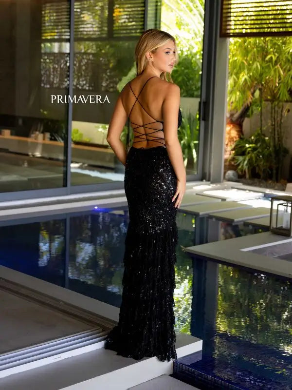 Step into the spotlight in the Primavera Couture 4122 Long Prom Dress. With a plunging V-neck and corset top, this dress is sure to turn heads. The layered ruffles and intricate sequin beading add a touch of elegance, making it perfect for any formal event or pageant. Feel confident and glamorous in this stunning gown.