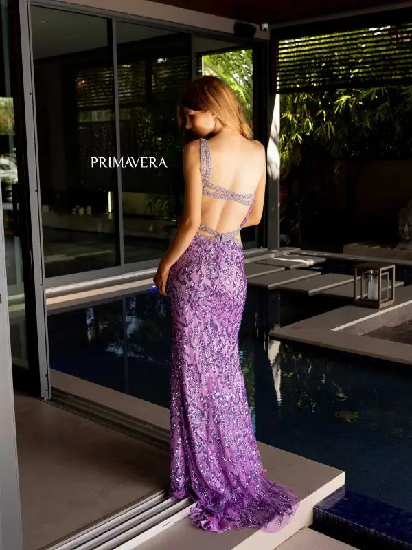 Elevate your formal look with exquisite Primavera Couture 4126 Long Prom Dress. Adorned with beaded straps and shimmering sequins, this fitted gown features a high slit for added elegance. Perfect for pageants and proms, make a statement with this glamorous and sophisticated gown.