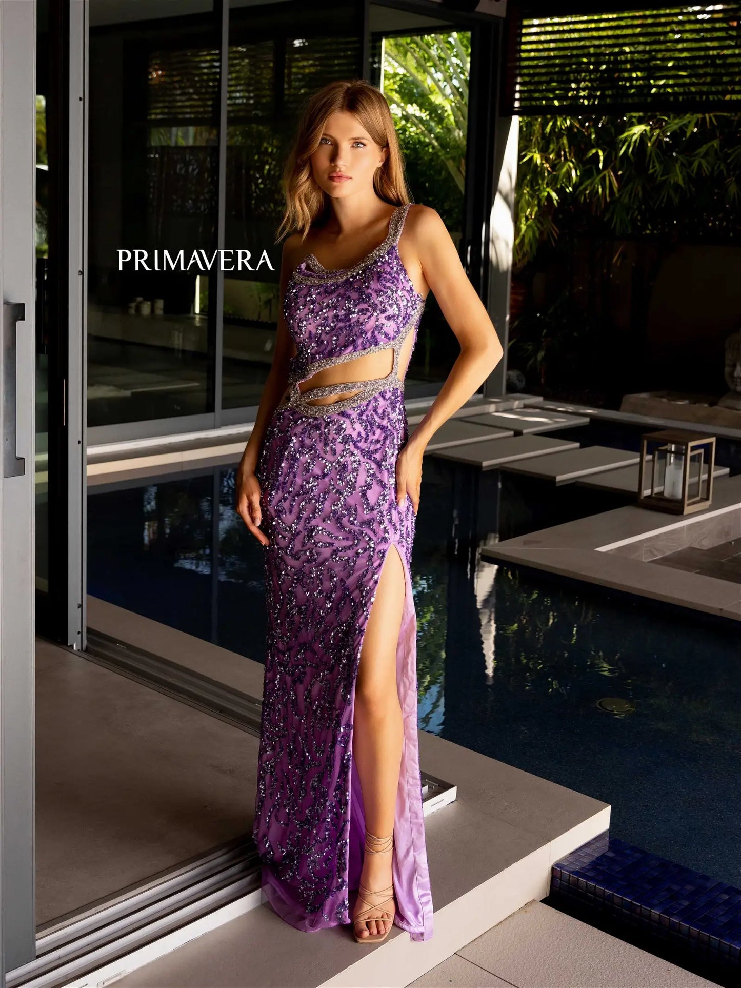 Elevate your formal look with exquisite Primavera Couture 4126 Long Prom Dress. Adorned with beaded straps and shimmering sequins, this fitted gown features a high slit for added elegance. Perfect for pageants and proms, make a statement with this glamorous and sophisticated gown.