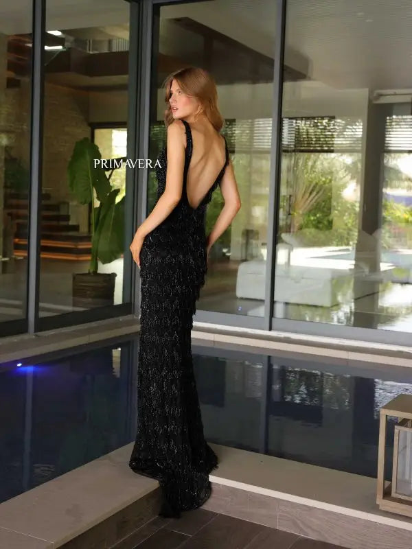 Slay the night in this stunning Primavera Couture 4129 Long Prom Dress. With fringes and sequins embellishing the tank straps and an open back, this formal pageant gown is sure to turn heads. The perfect combination of elegance and glamour for any special occasion.