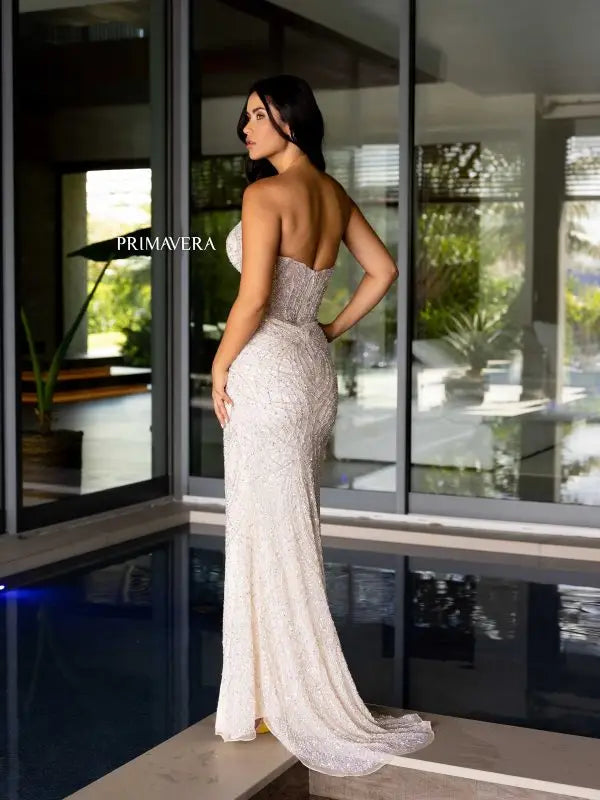Elevate your formal event style with the stunning Primavera Couture 4130 Long Prom Dress. The fitted silhouette and high slit showcase your figure, while the sequin and beaded detailing add a touch of glamour. The strapless sweetheart neckline completes the elegant look. Perfect for prom or pageants, this gown will make you feel confident and sophisticated.