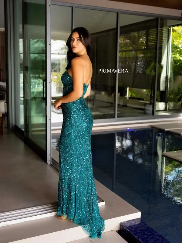 Elevate your formal event style with the stunning Primavera Couture 4130 Long Prom Dress. The fitted silhouette and high slit showcase your figure, while the sequin and beaded detailing add a touch of glamour. The strapless sweetheart neckline completes the elegant look. Perfect for prom or pageants, this gown will make you feel confident and sophisticated.