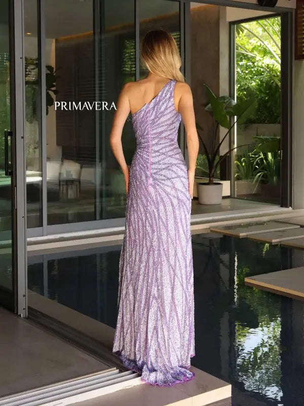 Impress the judges in the Primavera Couture 4133 formal pageant gown. With its asymmetrical neckline and sequin detailing, this dress exudes elegance. The high side slit adds a touch of sophistication, while the back design adds a modern twist. Perfect for making a statement and standing out on stage.
