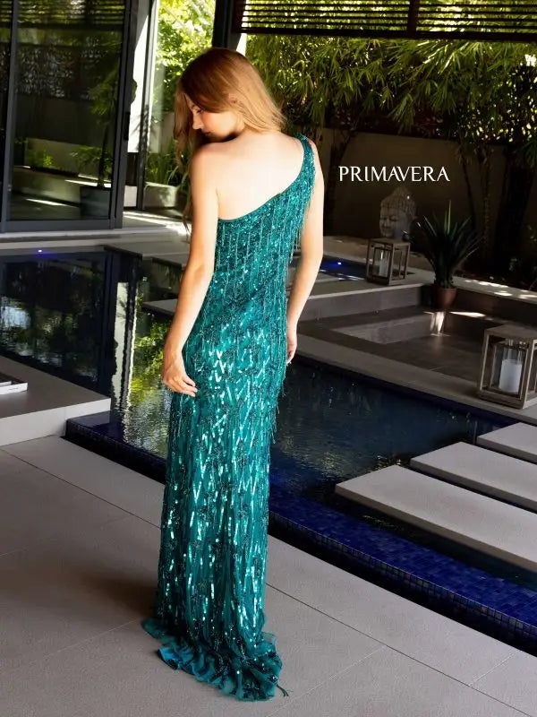 The Primavera Couture 4157 Long Prom Dress is a stunning gown that exudes elegance and sophistication. With a fitted silhouette and high slit, this dress accentuates your curves and adds a touch of glamour. The one shoulder design is adorned with sequin fringes, adding a playful yet refined touch. Perfect for formal events and pageants, this dress is sure to make you stand out.