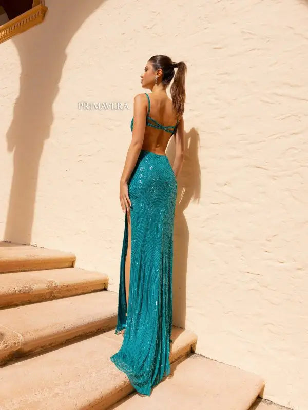 Expertly crafted by Primavera Couture 4159, this stunning long prom dress features a deep V neck, fitted silhouette, and a high slit for a seductive look. The open back and beaded straps add an extra touch of elegance. Perfect for making a lasting impression at your next formal event.