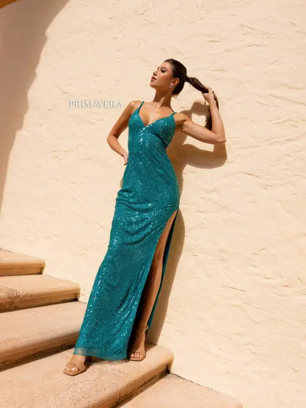Expertly crafted by Primavera Couture 4159, this stunning long prom dress features a deep V neck, fitted silhouette, and a high slit for a seductive look. The open back and beaded straps add an extra touch of elegance. Perfect for making a lasting impression at your next formal event.