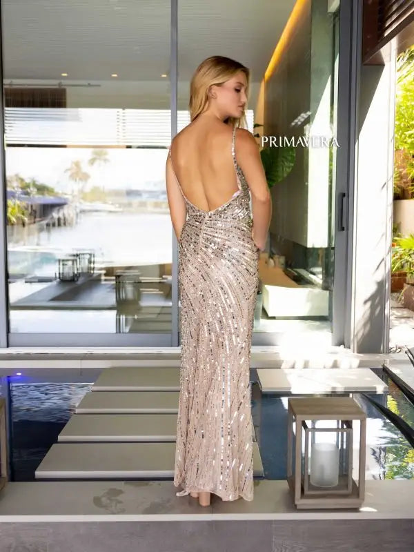 Elevate your formal attire with the Primavera Couture 4171 Long Prom Dress. The fitted silhouette and plunging V neckline highlight your curves, while the high slit adds a touch of alluring elegance. Adorned with shimmering sequins, this dress is perfect for any formal occasion.
