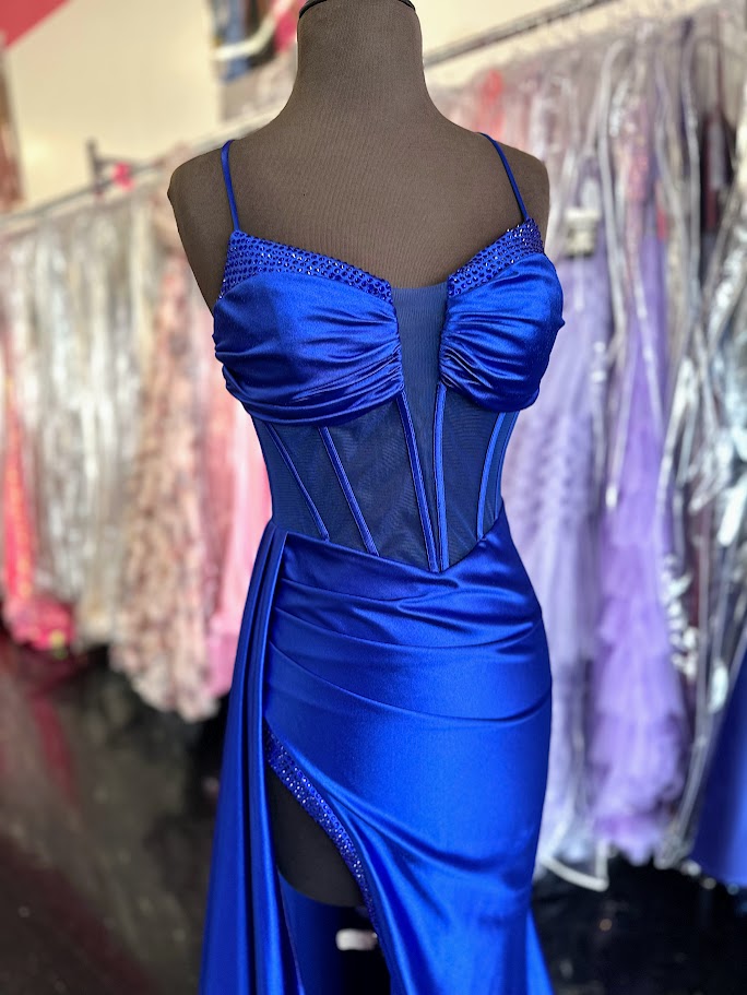 Elevate your evening with the Nina Canacci 4409, a size 4 royal long satin gown featuring a sheer corset bodice that contours elegantly. This sophisticated prom dress showcases a plunging neckline and a dramatic slit overskirt, blending classic glamour with modern allure—perfect for pageants or formal occasions.

Size: 4&nbsp;

Color: Royal