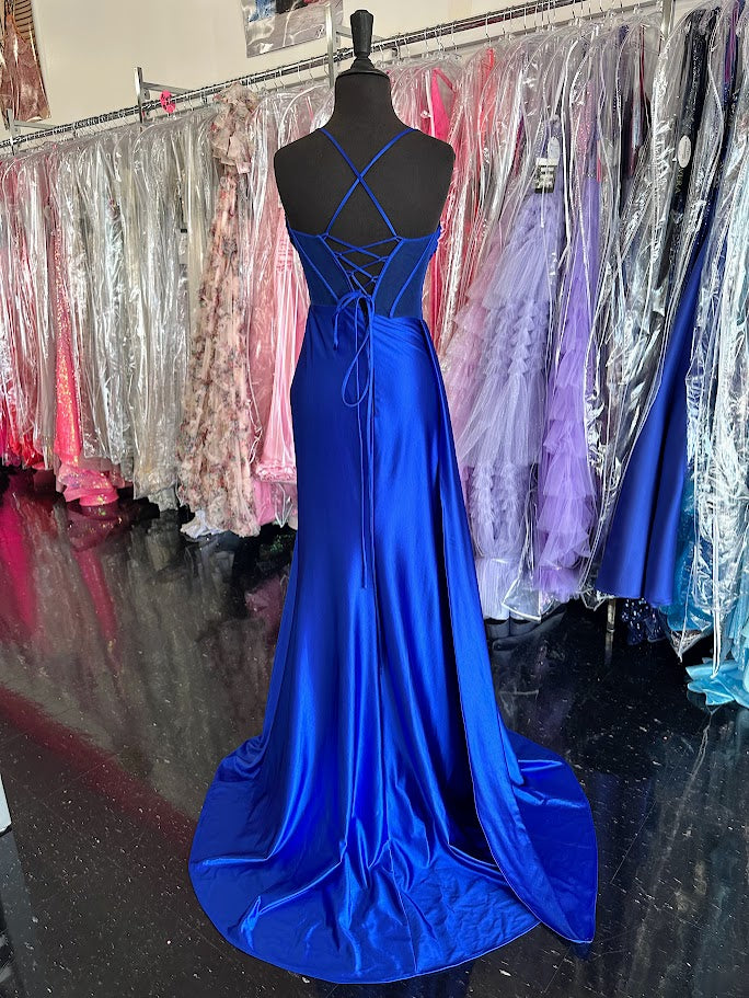 Elevate your evening with the Nina Canacci 4409, a size 4 royal long satin gown featuring a sheer corset bodice that contours elegantly. This sophisticated prom dress showcases a plunging neckline and a dramatic slit overskirt, blending classic glamour with modern allure—perfect for pageants or formal occasions.

Size: 4&nbsp;

Color: Royal