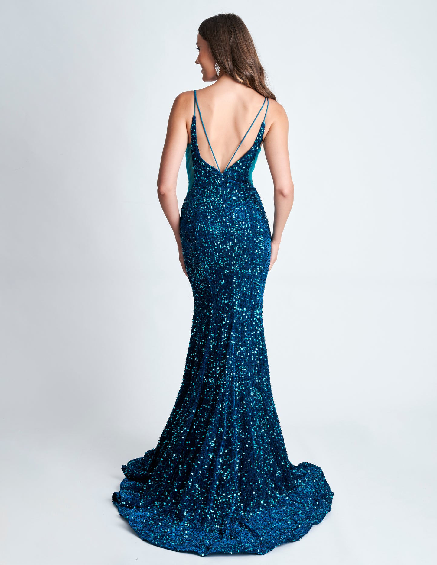 Elevate your style with the Nina Canacci 4420 Velvet Sequin Mermaid Prom Dress. Featuring a striking sheer v-neckline and stunning velvet sequin design, this formal evening gown is sure to make a statement. With its flattering mermaid silhouette, it's the perfect choice for a prom or special occasion.