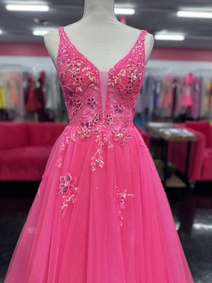 This Nina Canacci 4427 ballgown in size 4 showcases exquisite sequin lace detailing over a sheer bodice, creating a refined and elegant look. The flattering V-neckline and classic A-line silhouette enhance your figure while offering graceful movement. Perfect for prom or formal events, this gown combines timeless sophistication with subtle sparkle for a memorable evening.

Size: 4

Color: Fuchsia