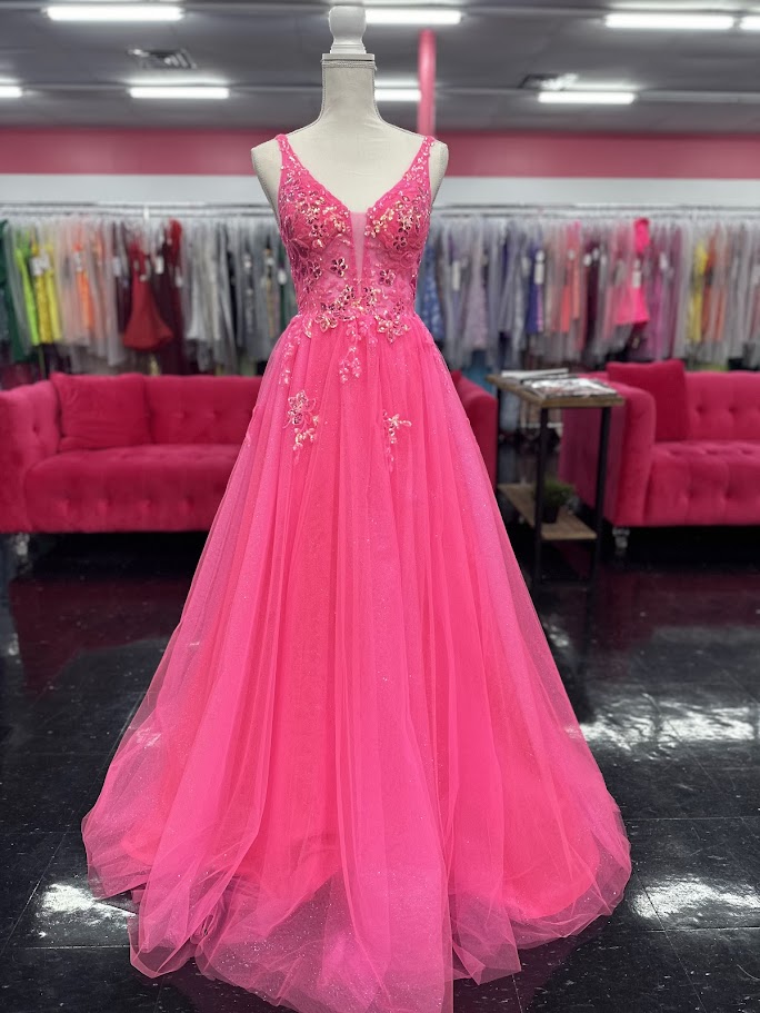 This Nina Canacci 4427 ballgown in size 4 showcases exquisite sequin lace detailing over a sheer bodice, creating a refined and elegant look. The flattering V-neckline and classic A-line silhouette enhance your figure while offering graceful movement. Perfect for prom or formal events, this gown combines timeless sophistication with subtle sparkle for a memorable evening.

Size: 4

Color: Fuchsia