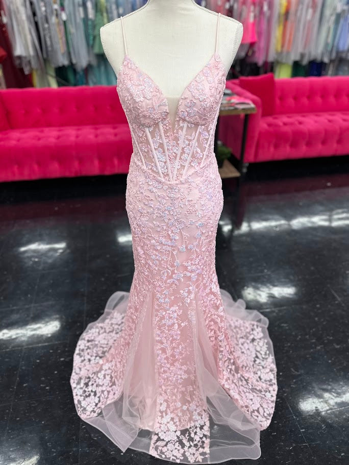 Elevate your formal occasion with the Nina Canacci 4434 gown, designed in a delicate peach hue. This size 4 mermaid dress features a sheer lace corset bodice adorned with subtle sequins, creating an elegant shimmer. The flattering V-neckline enhances your silhouette, while the fitted mermaid skirt offers a graceful, sophisticated finish perfect for prom or any special event.

Size: 4

Color: Peach