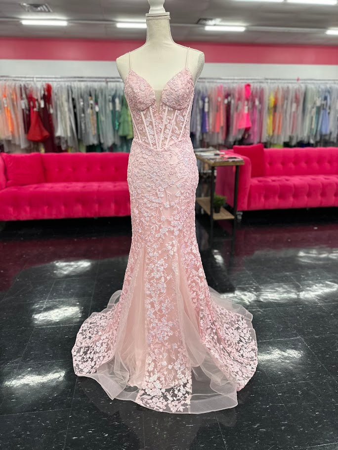 Elevate your formal occasion with the Nina Canacci 4434 gown, designed in a delicate peach hue. This size 4 mermaid dress features a sheer lace corset bodice adorned with subtle sequins, creating an elegant shimmer. The flattering V-neckline enhances your silhouette, while the fitted mermaid skirt offers a graceful, sophisticated finish perfect for prom or any special event.

Size: 4

Color: Peach