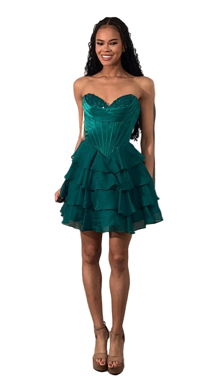 The Jovani 47763 combines elegance and youthful flair in a short cocktail dress designed for standout occasions like homecoming. Featuring a delicate lace-adorned cowl neckline and a structured corset bodice, it offers a flattering silhouette that enhances your figure. The ruffle flared skirt adds movement and a playful touch, balancing sophistication with charm. Ideal for events requiring both style and comfort, this dress ensures you make a memorable impression with expert craftsmanship and detail.

Sizes