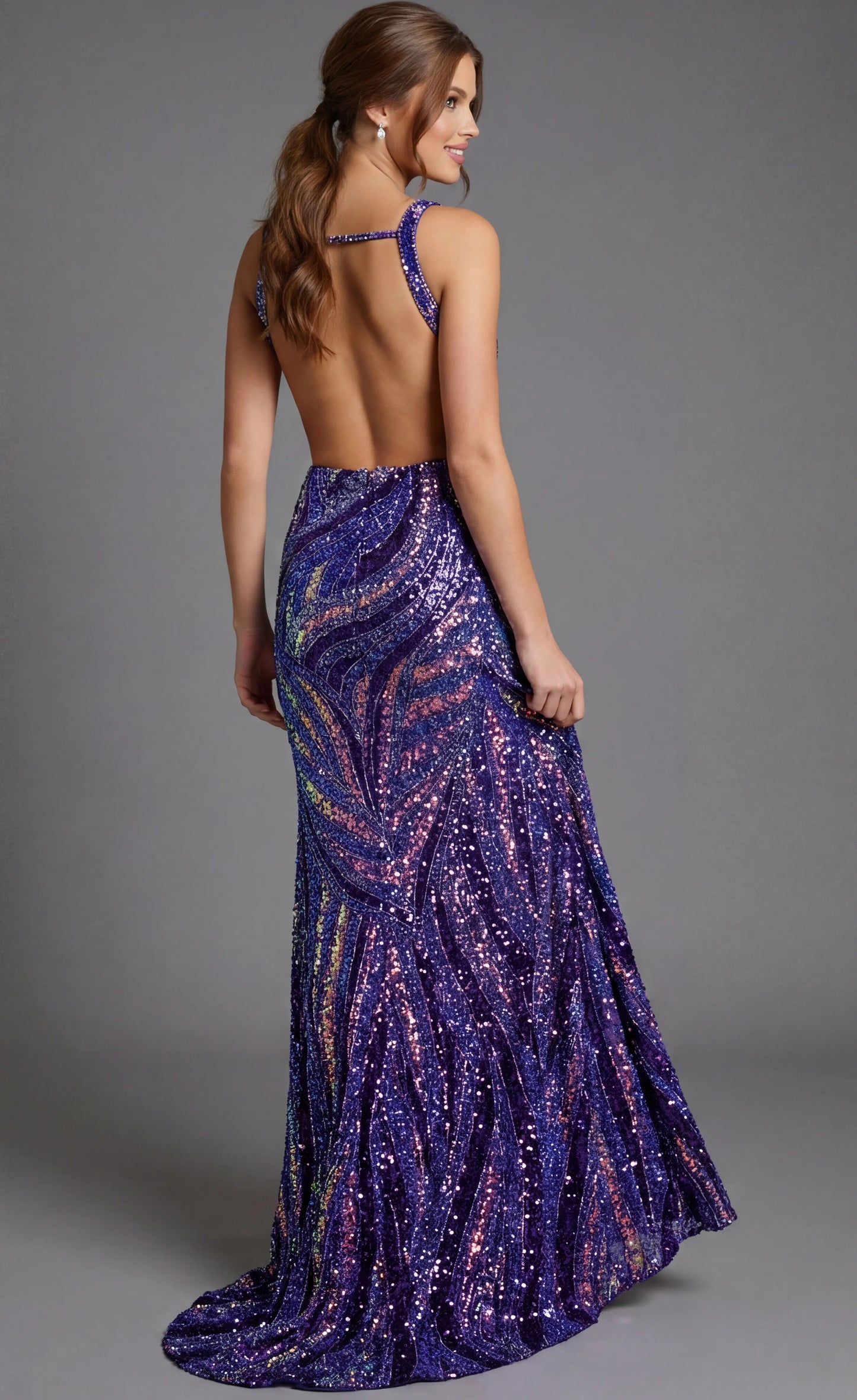 Make a statement in this stunning Jovani 47793 backless prom dress. Crafted in rich purple with multicolor sequin and bead embellishments, this pageant gown features a daring deep V neckline, strategic side cutouts, and a thigh-high slit that commands attention. The sculpted silhouette and shimmering details create an unforgettable, glamorous look perfect for prom, pageants, or any formal occasion where you want to shine.

Sizes: 00-24

Colors: Dark Green Multi, Neon Pink/Multi, Nude/Multi, Peacock/Multi, P