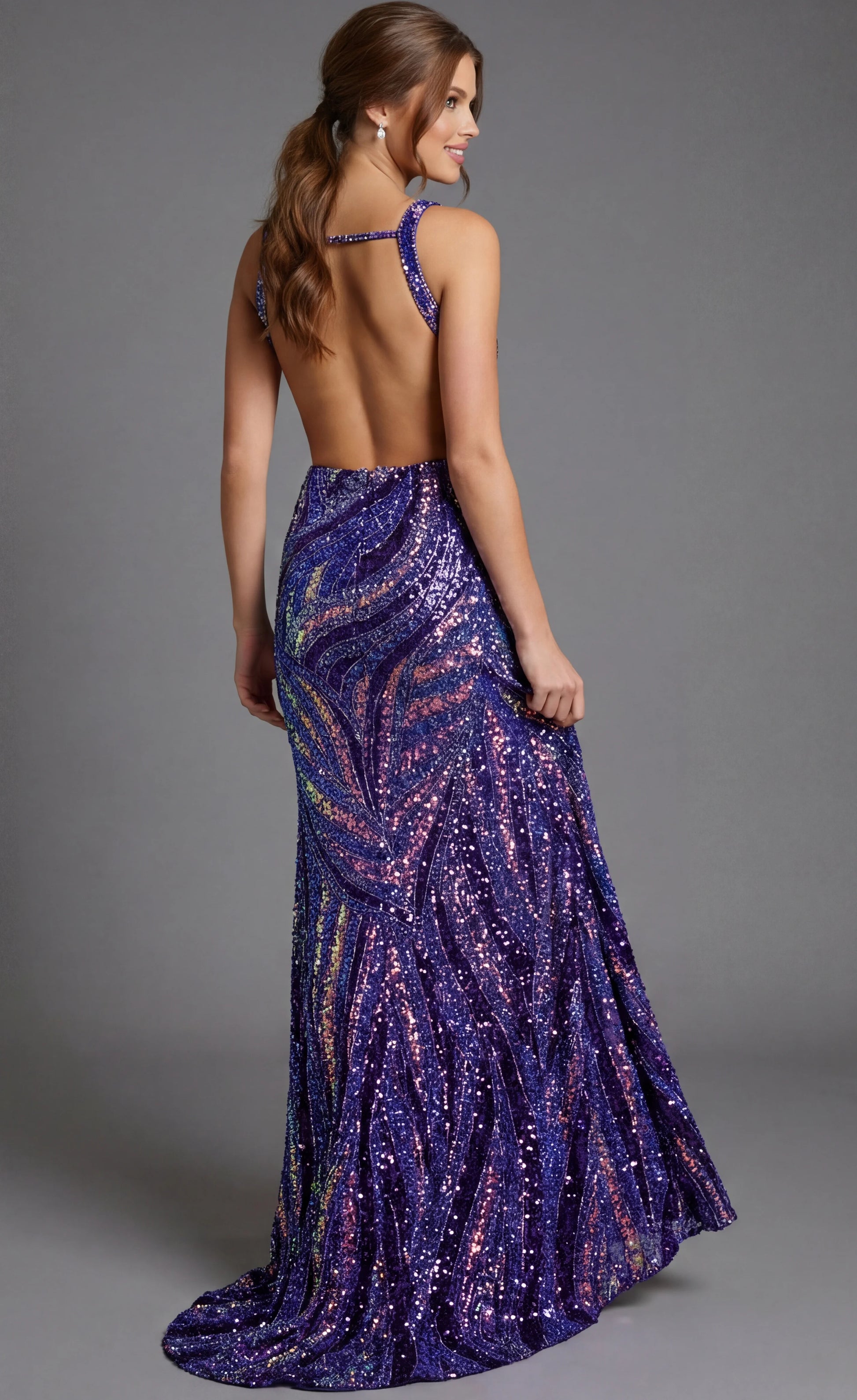 Make a statement in this stunning Jovani 47793 backless prom dress. Crafted in rich purple with multicolor sequin and bead embellishments, this pageant gown features a daring deep V neckline, strategic side cutouts, and a thigh-high slit that commands attention. The sculpted silhouette and shimmering details create an unforgettable, glamorous look perfect for prom, pageants, or any formal occasion where you want to shine.

Sizes: 00-24

Colors: Dark Green Multi, Neon Pink/Multi, Nude/Multi, Peacock/Multi, P