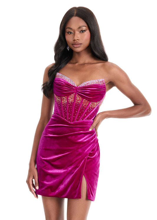 Elevate your evening with the Ashley Lauren 4865, a short fitted velvet corset dress designed to captivate. Featuring a pointed V-neck and a crystal-embellished slit, this cocktail gown combines elegance with a touch of allure. Its luxurious velvet fabric and structured corset silhouette ensure a flattering fit, perfect for homecoming or any special occasion where sophistication is key.&nbsp; Make a striking entrance in ASHLEYlauren Style 4865, a velvet mini dress featuring a beaded corset bodice with a swe