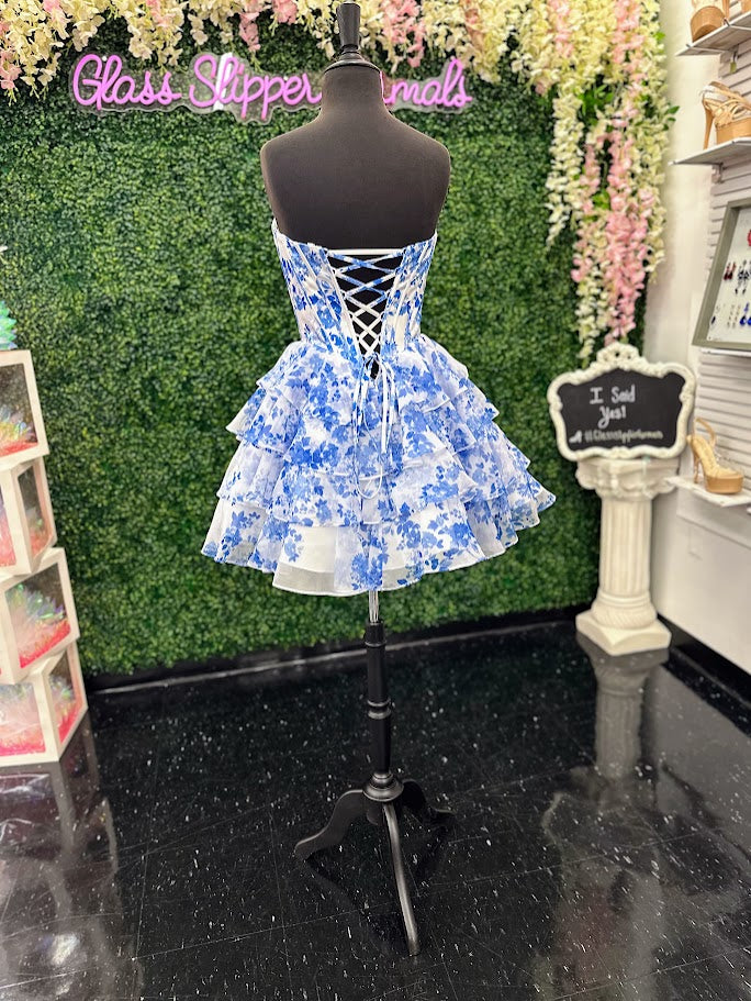 This Jovani 48771 homecoming dress features a flattering fit-and-flare silhouette with a corset bodice for structured support. The short, A-line skirt is enhanced with delicate ruffles and a vibrant floral print, creating a youthful yet elegant look. Crafted with lace accents, this cocktail dress balances sophistication and playful charm, making it an ideal choice for memorable celebrations and formal events.

Sizes: 00-24

Colors: Blue Print, Blush Print, Green Print