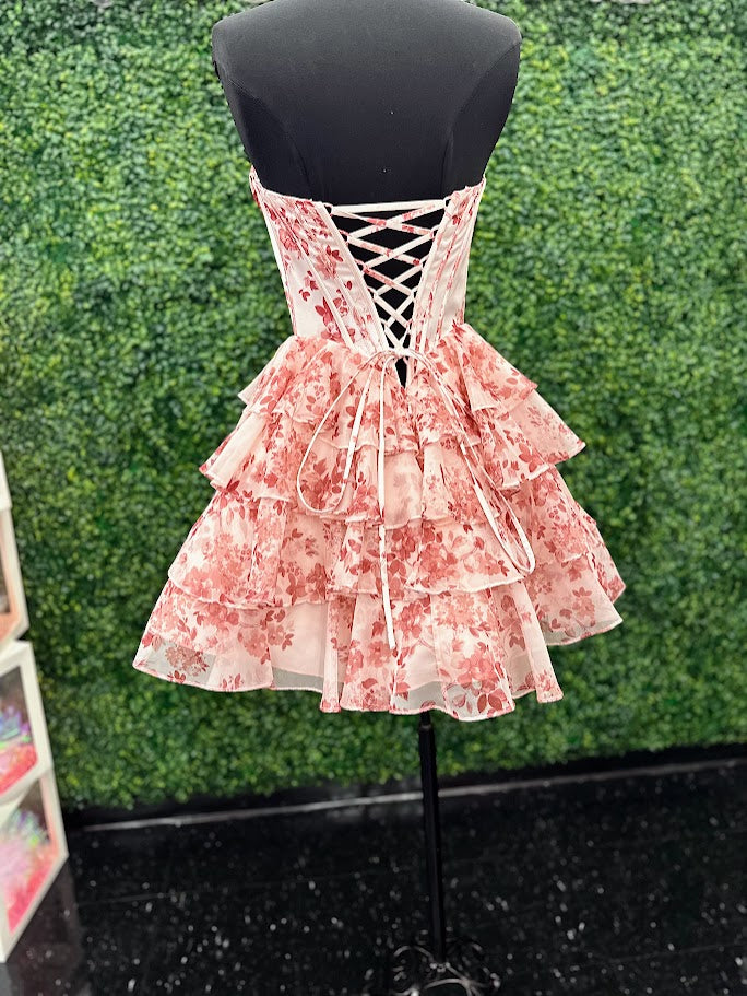 This Jovani 48771 homecoming dress features a flattering fit-and-flare silhouette with a corset bodice for structured support. The short, A-line skirt is enhanced with delicate ruffles and a vibrant floral print, creating a youthful yet elegant look. Crafted with lace accents, this cocktail dress balances sophistication and playful charm, making it an ideal choice for memorable celebrations and formal events.

Sizes: 00-24

Colors: Blue Print, Blush Print, Green Print