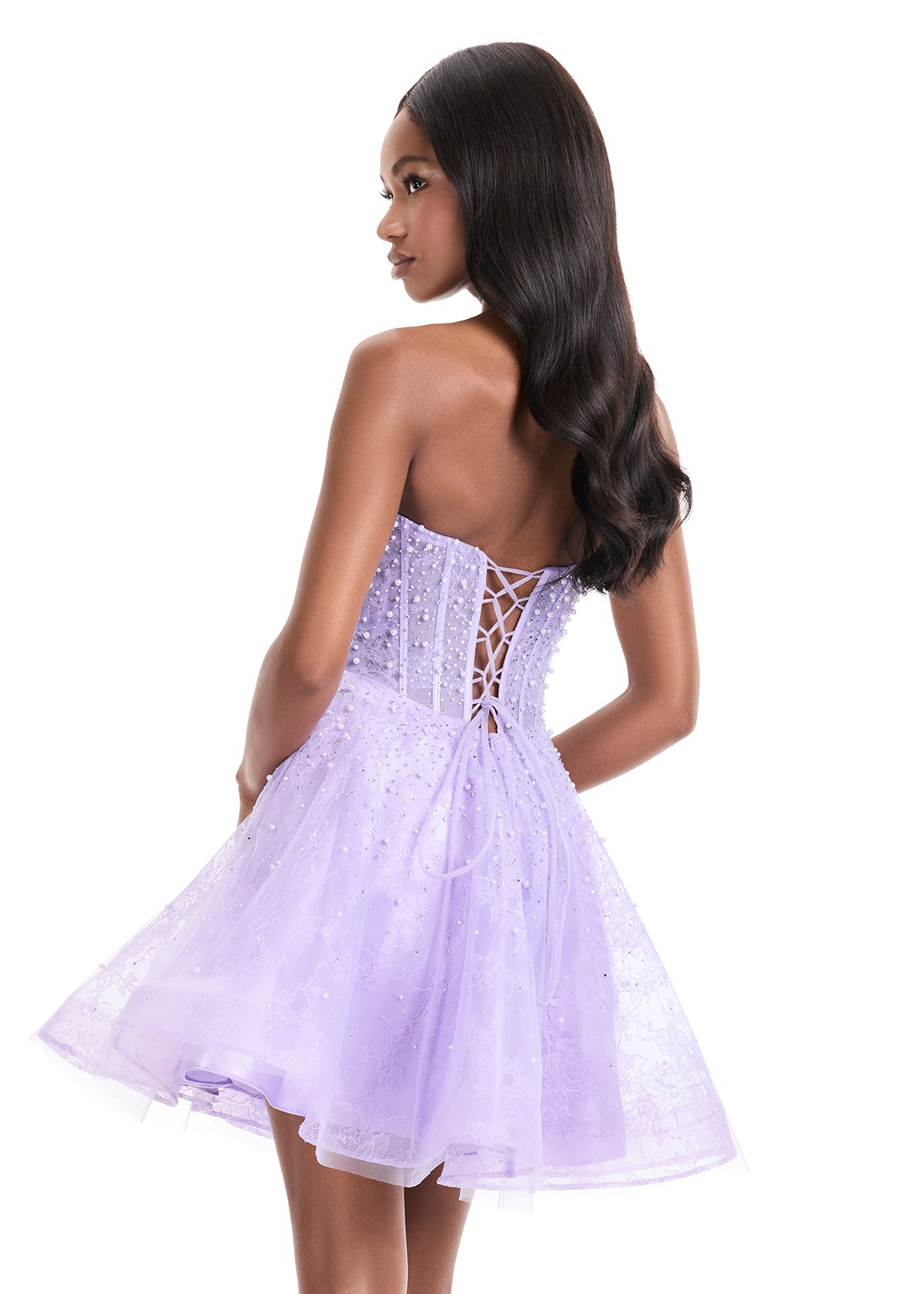 The Ashley Lauren 4924 Short Lace Cocktail Dress combines delicate lace with a sheer corset bodice, adorned with intricate beadwork for subtle elegance. Its fit-and-flare silhouette flatters the figure while providing comfortable movement, making it an excellent choice for formal events or homecoming. This dress balances classic design with modern detailing to create a sophisticated and stylish look. Feel elegant in the ASHLEYlauren Style 4924, a lace dress featuring intricate press-on beading throughout th