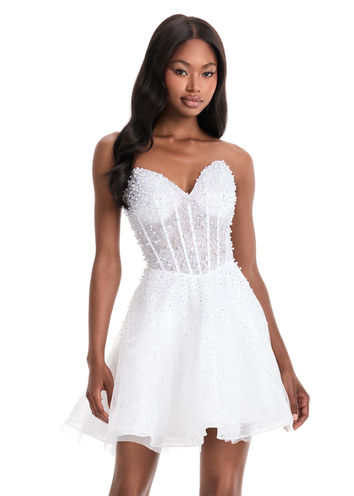 The Ashley Lauren 4924 Short Lace Cocktail Dress combines delicate lace with a sheer corset bodice, adorned with intricate beadwork for subtle elegance. Its fit-and-flare silhouette flatters the figure while providing comfortable movement, making it an excellent choice for formal events or homecoming. This dress balances classic design with modern detailing to create a sophisticated and stylish look. Feel elegant in the ASHLEYlauren Style 4924, a lace dress featuring intricate press-on beading throughout th