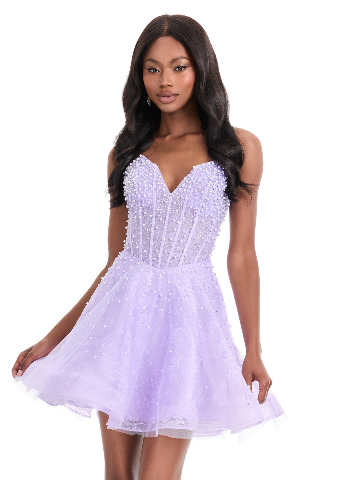 The Ashley Lauren 4924 Short Lace Cocktail Dress combines delicate lace with a sheer corset bodice, adorned with intricate beadwork for subtle elegance. Its fit-and-flare silhouette flatters the figure while providing comfortable movement, making it an excellent choice for formal events or homecoming. This dress balances classic design with modern detailing to create a sophisticated and stylish look. Feel elegant in the ASHLEYlauren Style 4924, a lace dress featuring intricate press-on beading throughout th