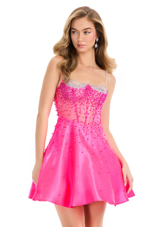 Elevate your evening with the Ashley Lauren 4927, a short flared cocktail gown that blends elegance and modern charm. Featuring a sheer beaded corset bodice, this dress offers a delicate sparkle that enhances your silhouette. Crafted from smooth satin, its flared skirt adds graceful movement, perfect for homecoming or special occasions. This gown combines&nbsp; refined details with a flattering fit to ensure you stand out with timeless sophistication.&nbsp; Stand out at any formal or cocktail event with ASH