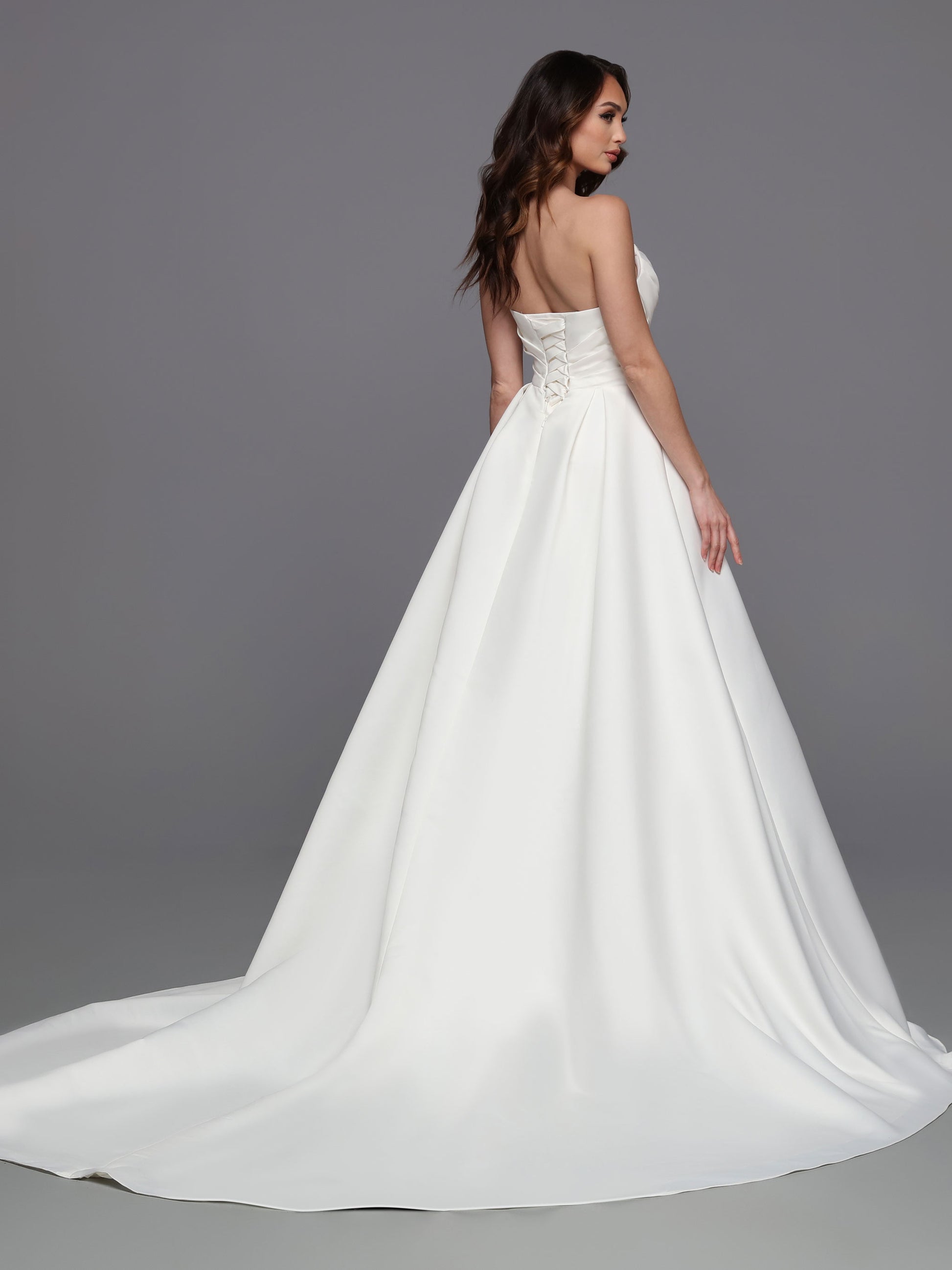 This stunning gown from Davinci Bridal is made from luxe satin and features a strapless faux-wrap bodice with a corset back and a slit maxi skirt for a modern, romantic look. The 50715 is perfect for a bride who wants a timeless style for her special day.  Sizes: 2-20  Colors: Ivory