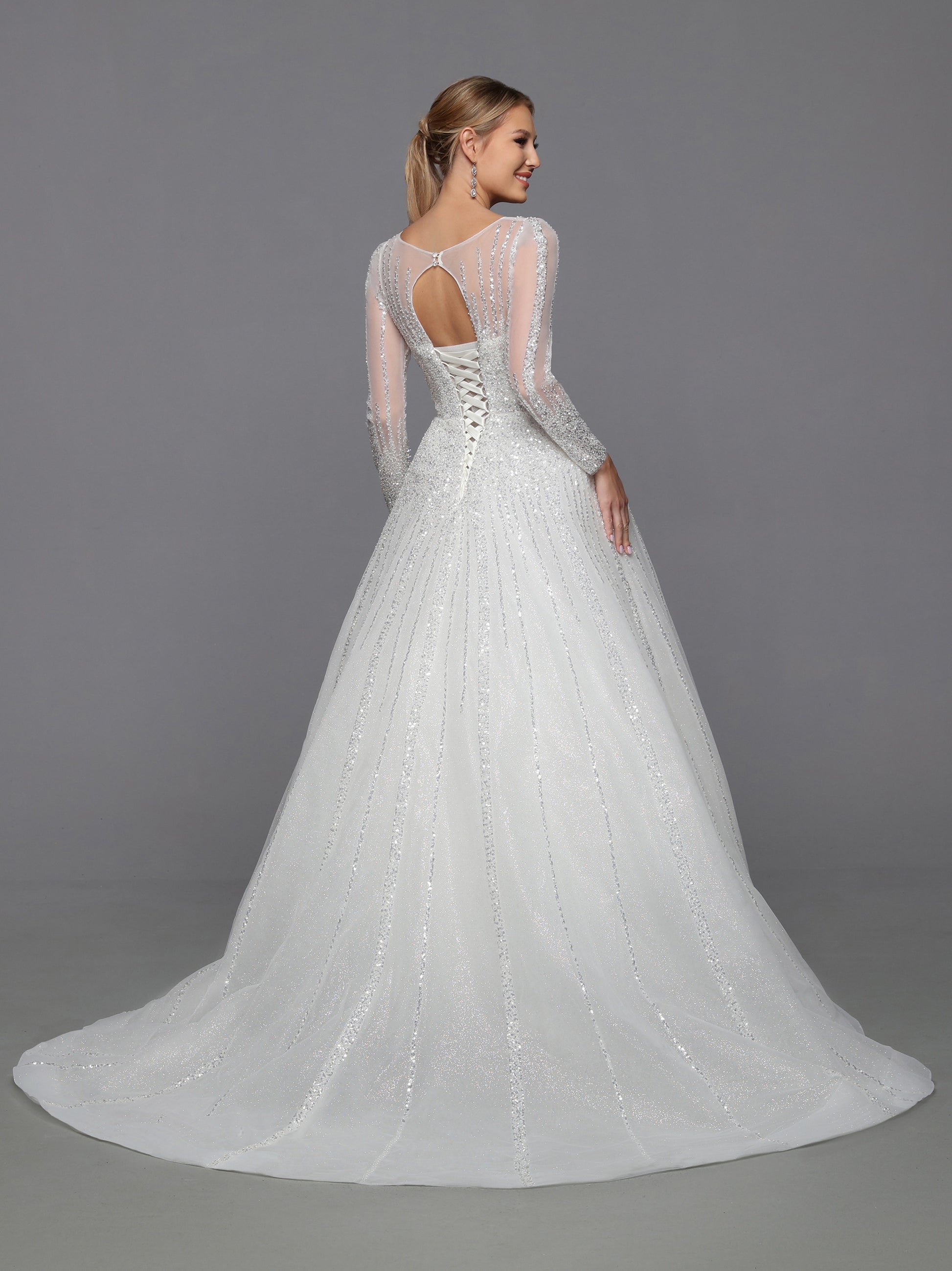 DaVinci Bridal 50764 A-Line Ballgown High Neck Long Sleeve Open Back Train Wedding Gown. On-trend glitter tulle brings this ball gown to life. Designer details include a sheer bodice, full-length sleeves, and a corset back.