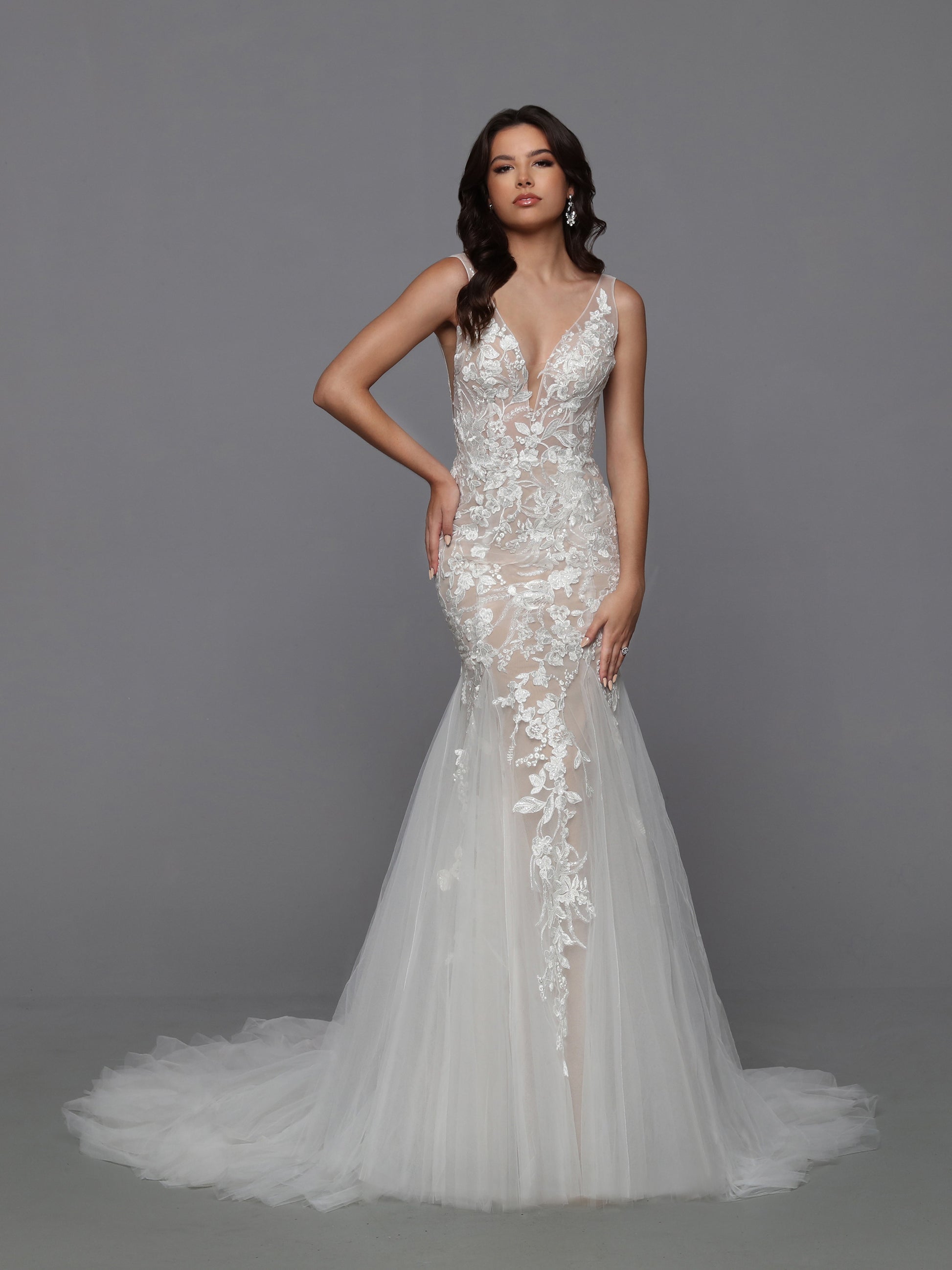 DaVinci Bridal 50765 Mermaid V-Neck Lace Applique Open Back Train Wedding Gown. Designer details of this classic silhouette include the option of a nude-look bodice with latte lining and gorgeous lace applique tracing the lines of the fluffy mermaid skirt.